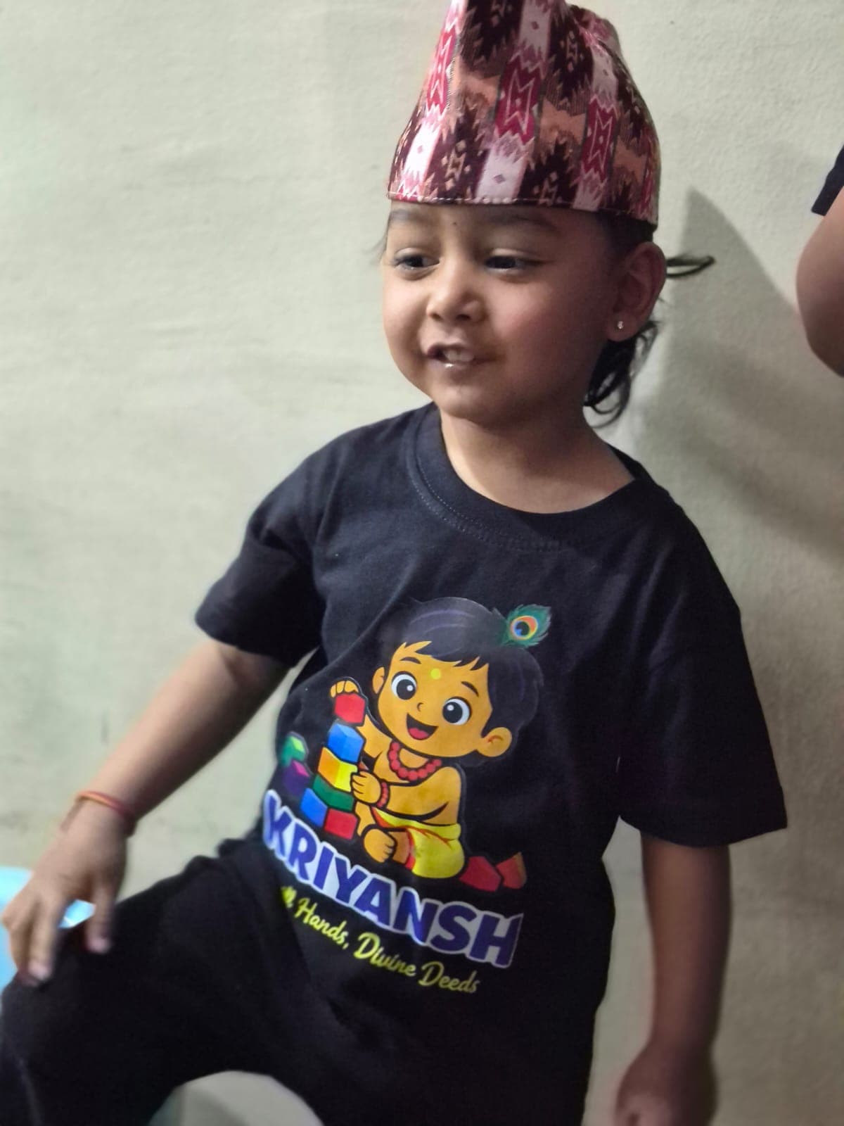 Child wearing a personalized Krishna T-shirt from TOTOPASA